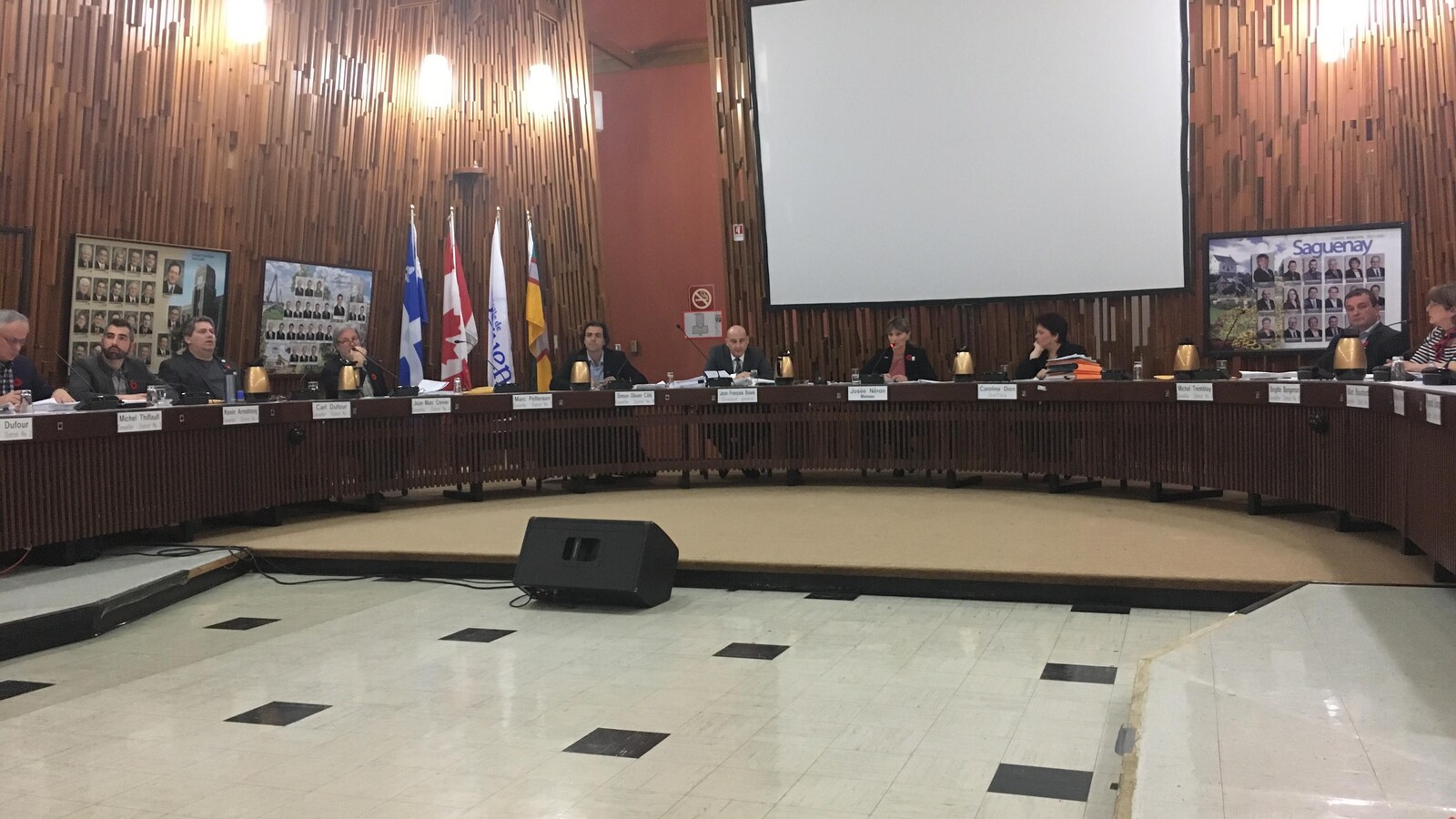 Des personnes sont assises dans la salle du conseil municipal de Saguenay.