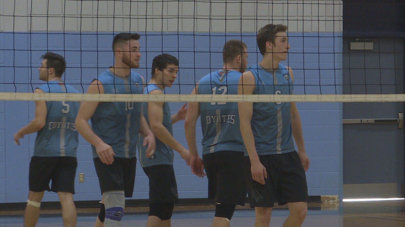 Des jeunes hommes qui jouent au volleyball.