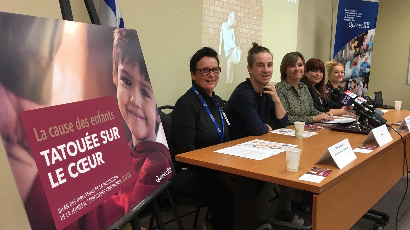 Cinq personnes assises à une table lors de la conférence de presse annuelle de la directrice de la protection de la jeunesse au Saguenay-Lac-Saint-Jean