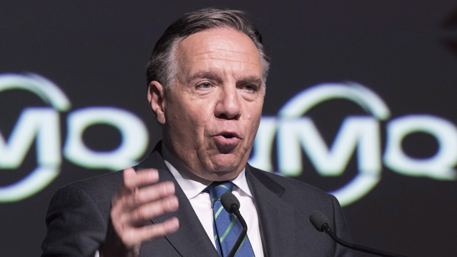 François Legault parler debout sur scène.