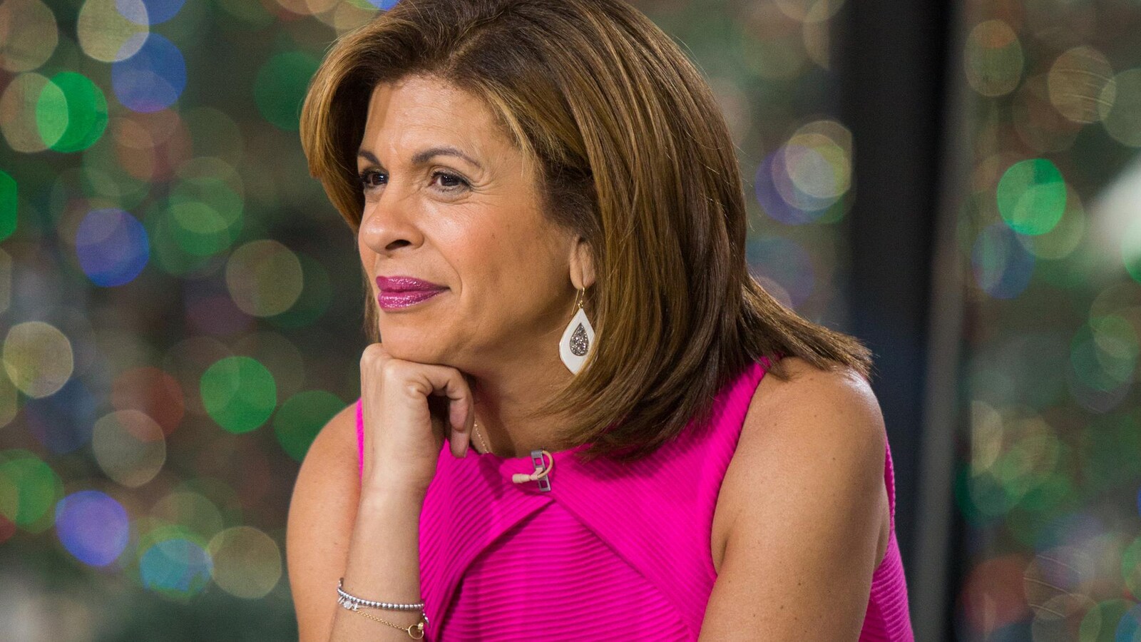 L'animatrice Hoda Kotb est accoudé sur le bureau de l'émission <i>Today</i>.