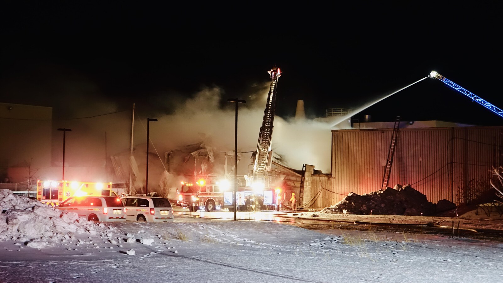 Des canons à eau en hauteur arrosent l'incendie.