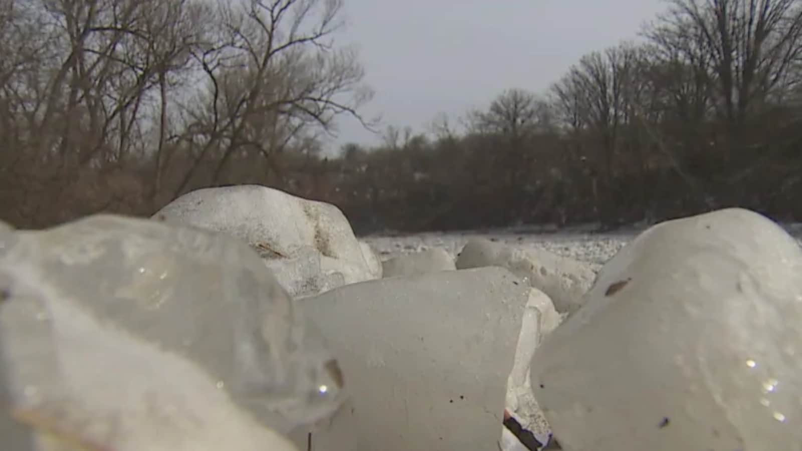Photo de blocs de glace sur le bord d'un cours d'eau enneigé