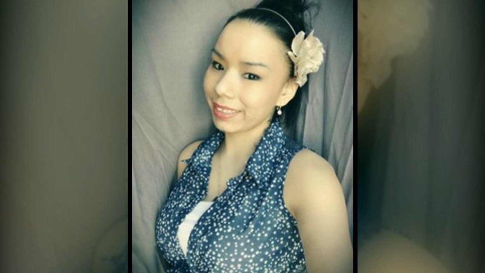 Une jeune femme avec une fleur dans les cheveux.