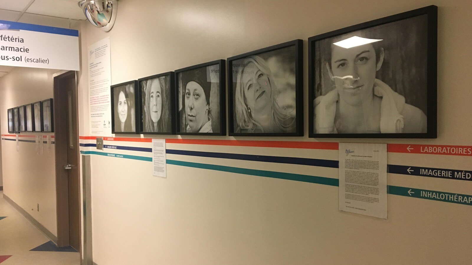 Des photos en noir et blanc de femmes encadrées sont accrochées au mur d'un hôpital.