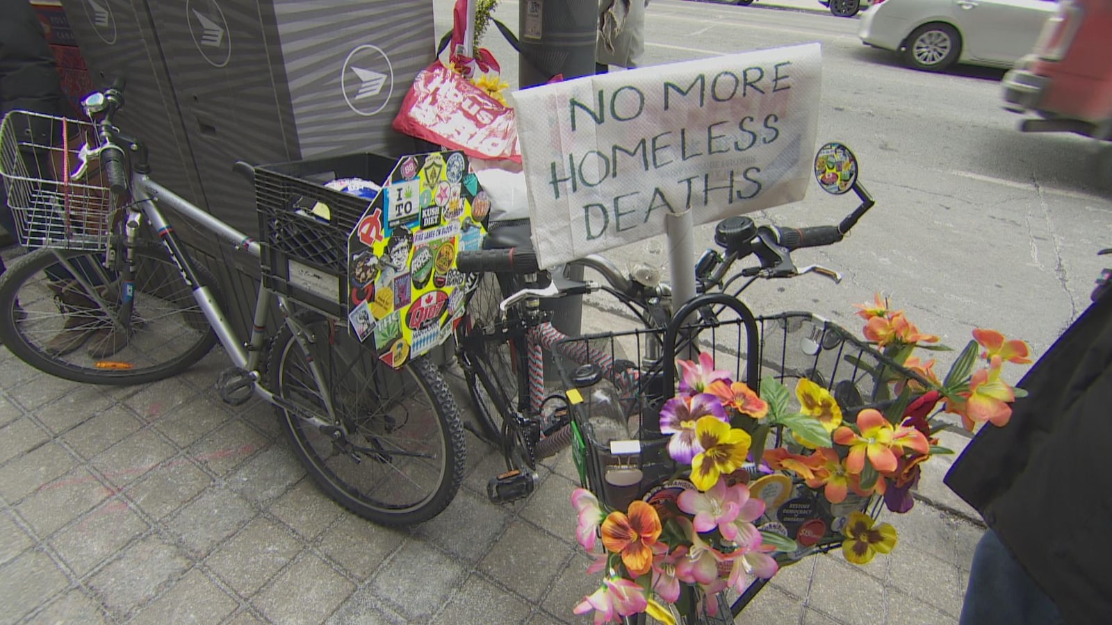 Des vélos portent des fleurs et des panneaux protestant contre l'insécurité des sans-abris.
