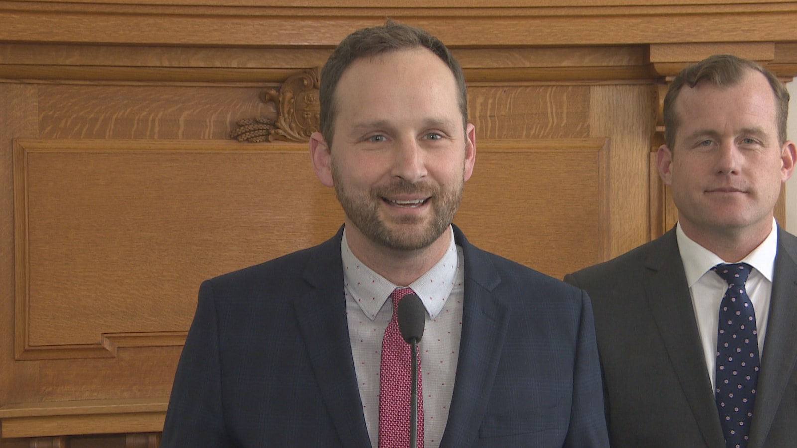 Ryan Meili et Trent Wotherspoon un à côté de l'autre dans une salle devant un micro