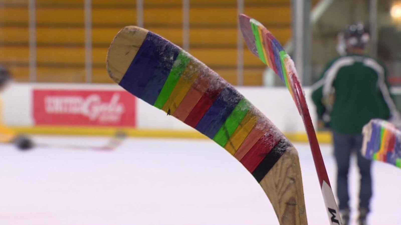 Un bâton de hockey est entourant d'un ruban multicolore.