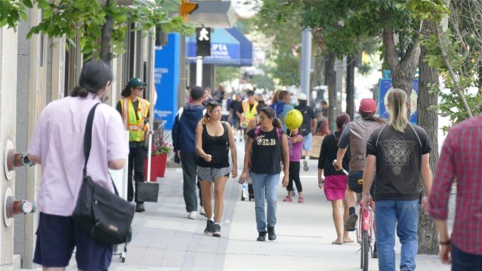 Image de gens marchant dans la rue d'une ville.
