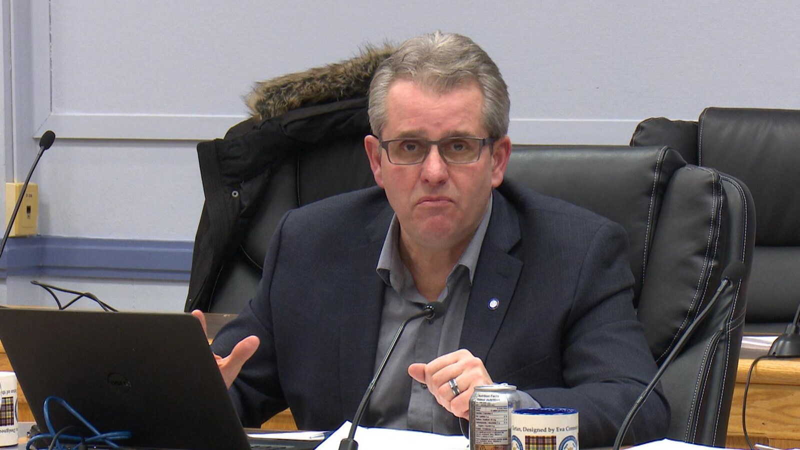 Le conseiller municipal de Timmins, Rick Dubeau, est en plein discours assis derrière un micro.