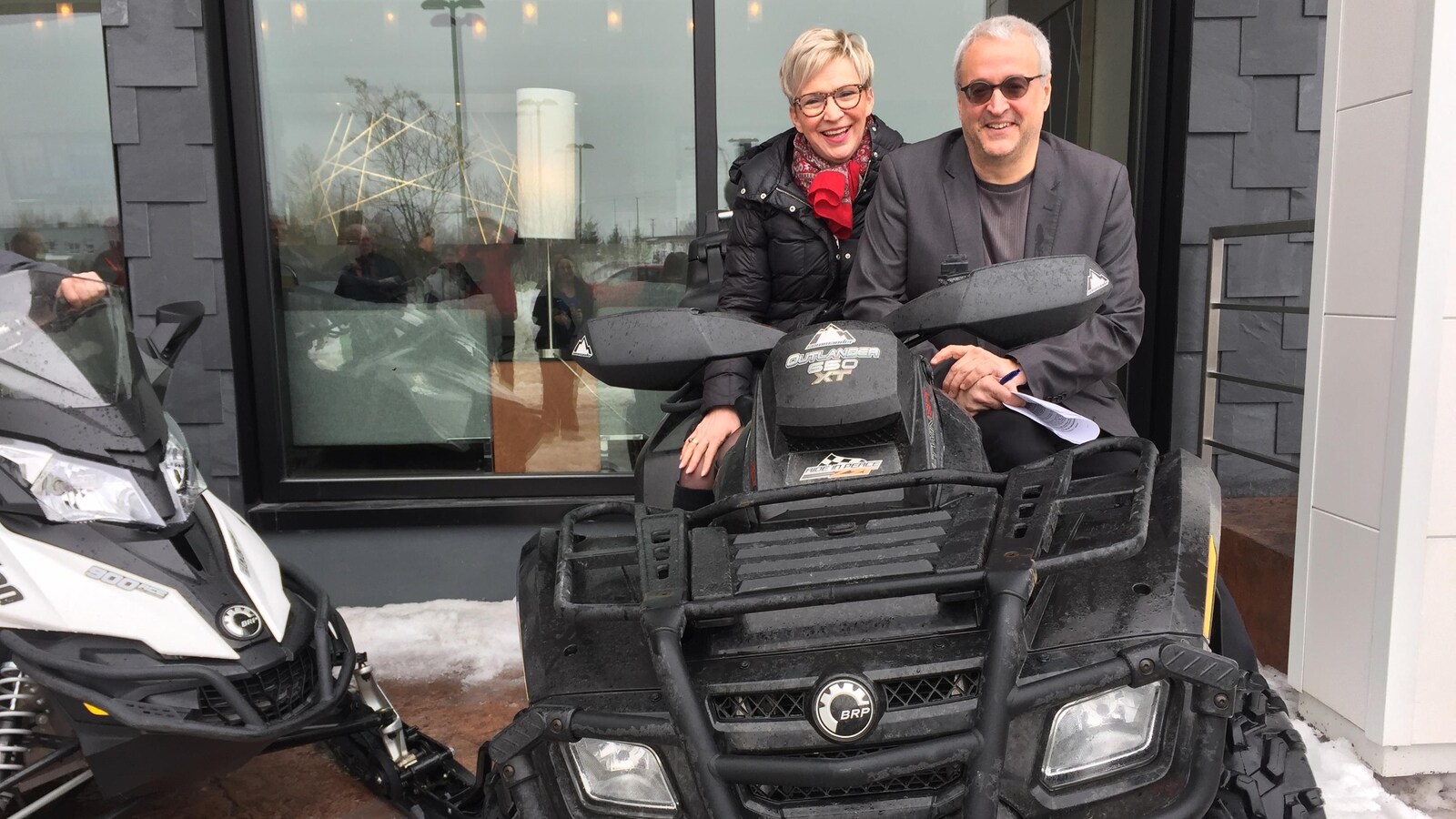 Suzanne Blais et Pierre Dufour sont assis sur un VTT, souriants.