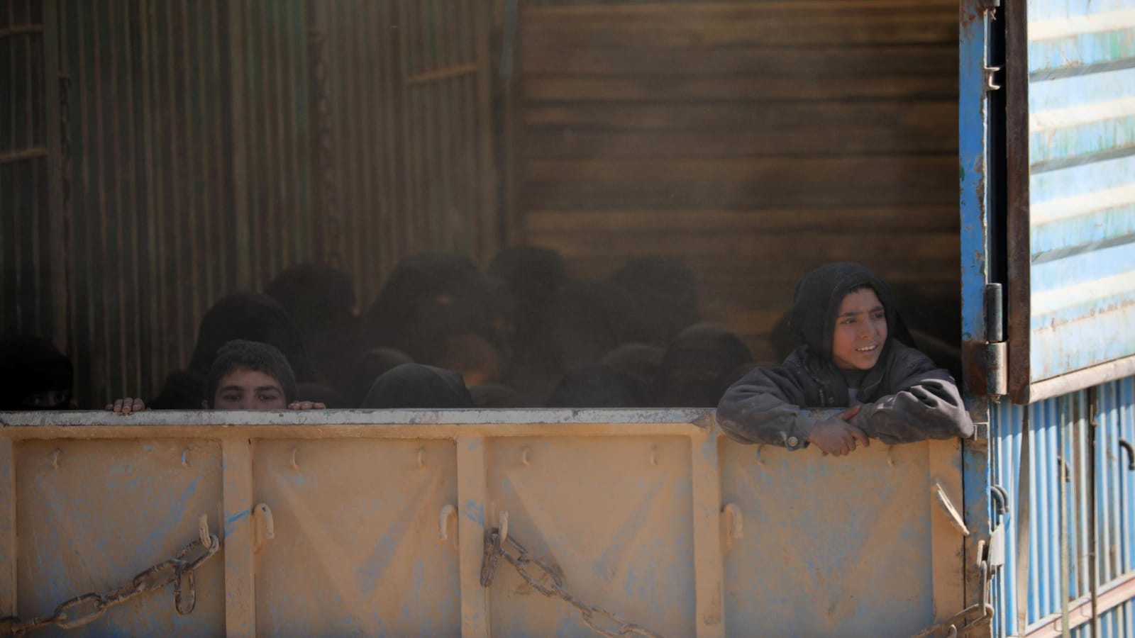 Femmes et enfants quittent le secteur de Baghouz, en Syrie, dans des camions.