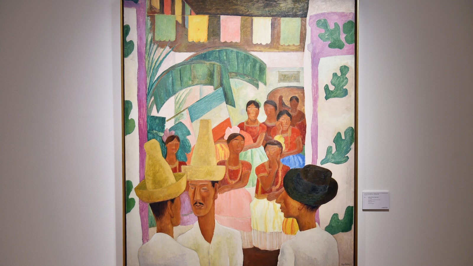 Le tableau <i>Los Rivales</i>, de Diego Rivera, où, en bas à gauche, deux hommes avec chapeau se font face lors d'une célébration traditionnelle mexicaine.