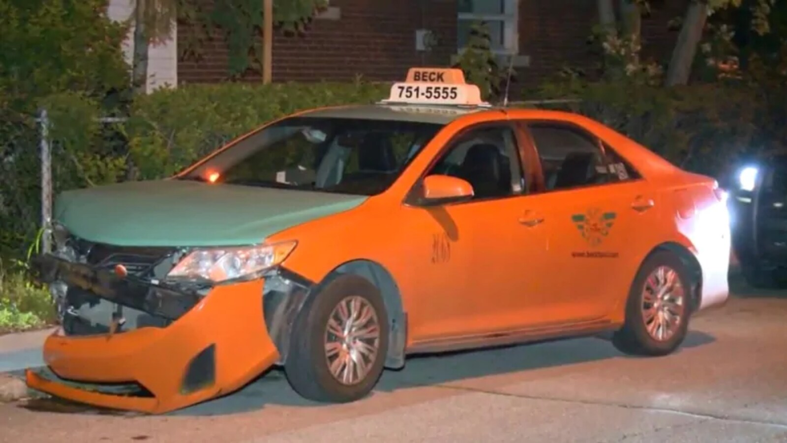 Photo d'une voiture orange au capot vert, embouti à l'avant