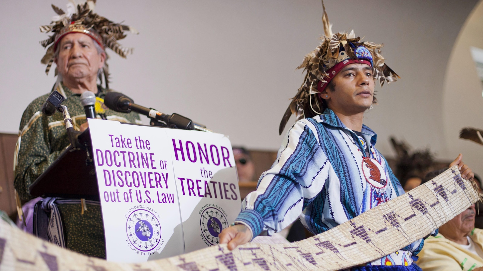 John Parsons, aka Tyhogeñhs, right, holds a historic wampum belt, that was commissioned by President George Washington ratifying the 1794 Treaty of Canandaigua, as Oren Lyons, left, Faitherkeeper, Turtle Clan, Onondaga Nation, answers question during a news conference in Washington, Tuesday, April 15, 2014. Onondaga Nation announced they will file a petition against the US with the Inter-American Commission on Human Rights (IACHR), claiming since 1788, 2.5 million acres of land have been stolen
