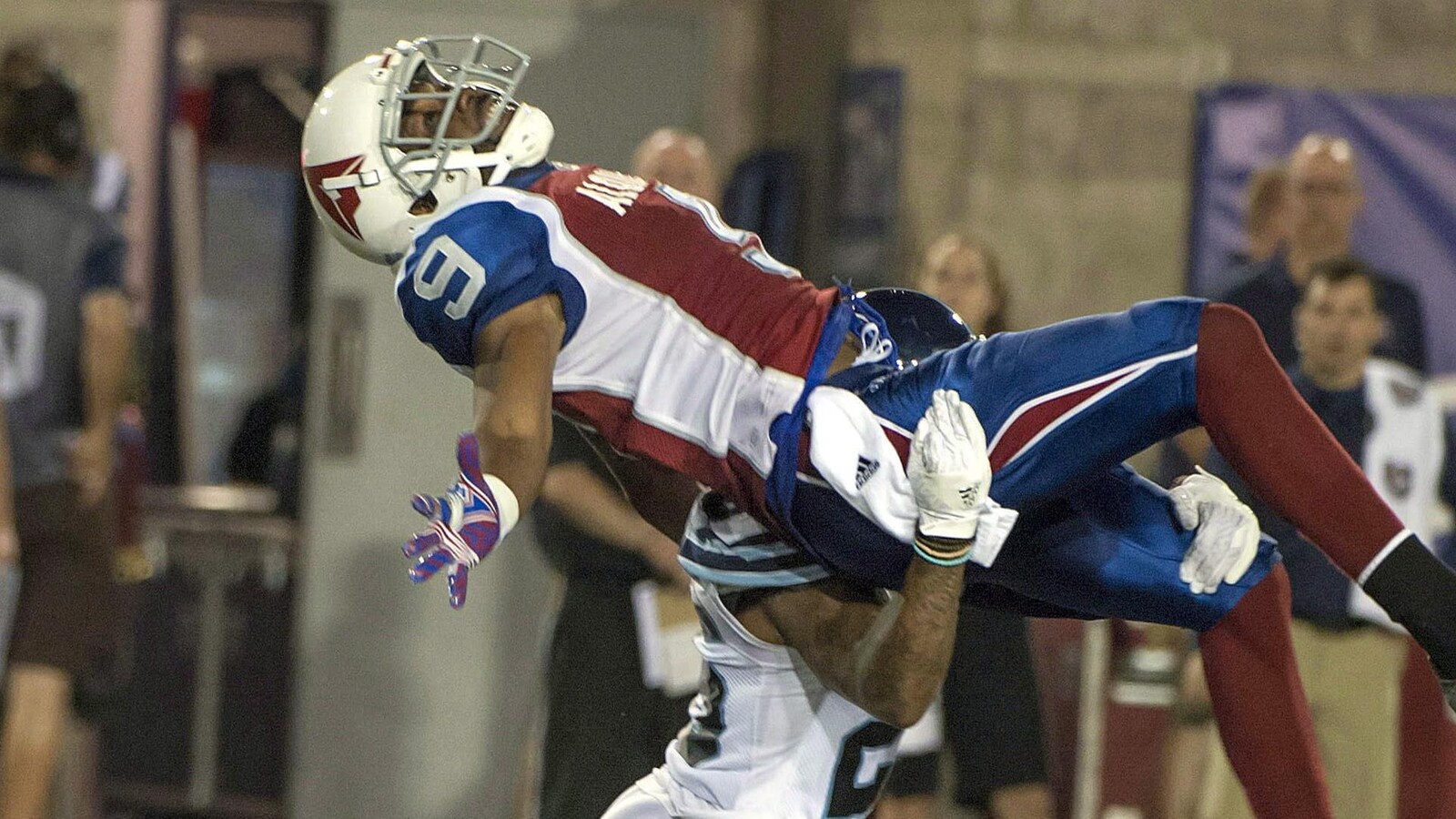 Ernest Jackson se fait culbuter par un joueur des Argonauts