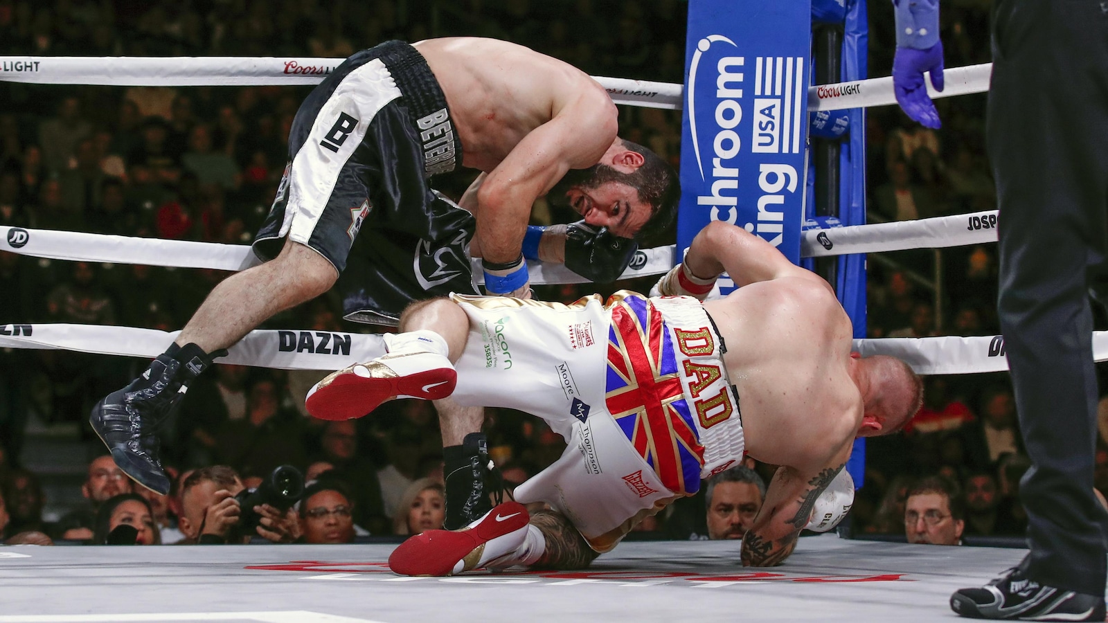 Artur Beterbiev, left, knocks down Callum Johnson during a boxing match Saturday, Oct. 6, 2018, in Chicago. (AP Photo/Kamil Krzaczynski)