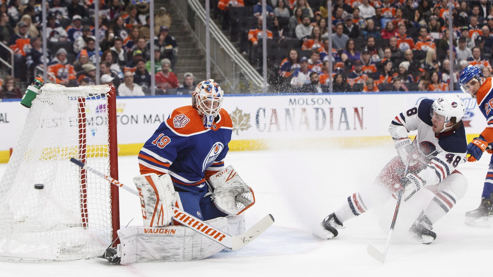 Brendan Lemieux (à droite), des Jets de Winnipeg, tente de battre le gardien des Oilers d'Edmonton Mikko Koskinen.