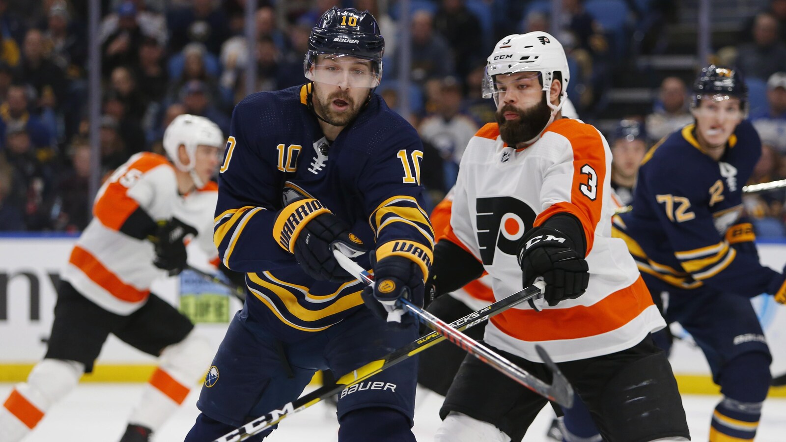 Patrik Berglund tient le bâton de Radko Gudas en échec pendant un match entre les Sabres et les Flyers de Philadelphie à Buffalo.