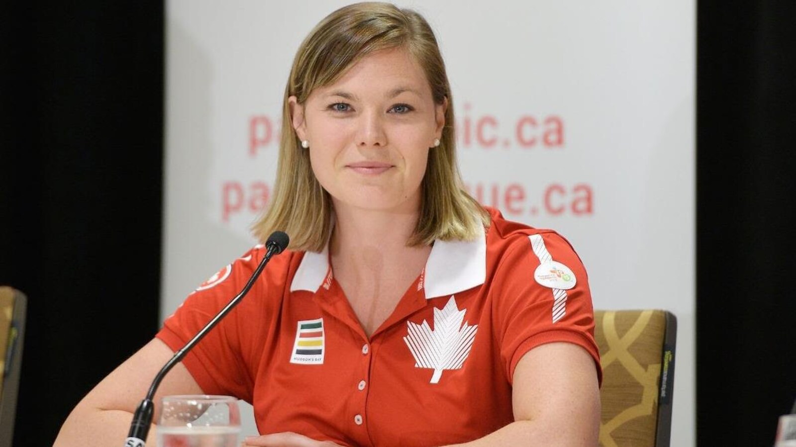 Elle porte une chemise au couleur du Canada.