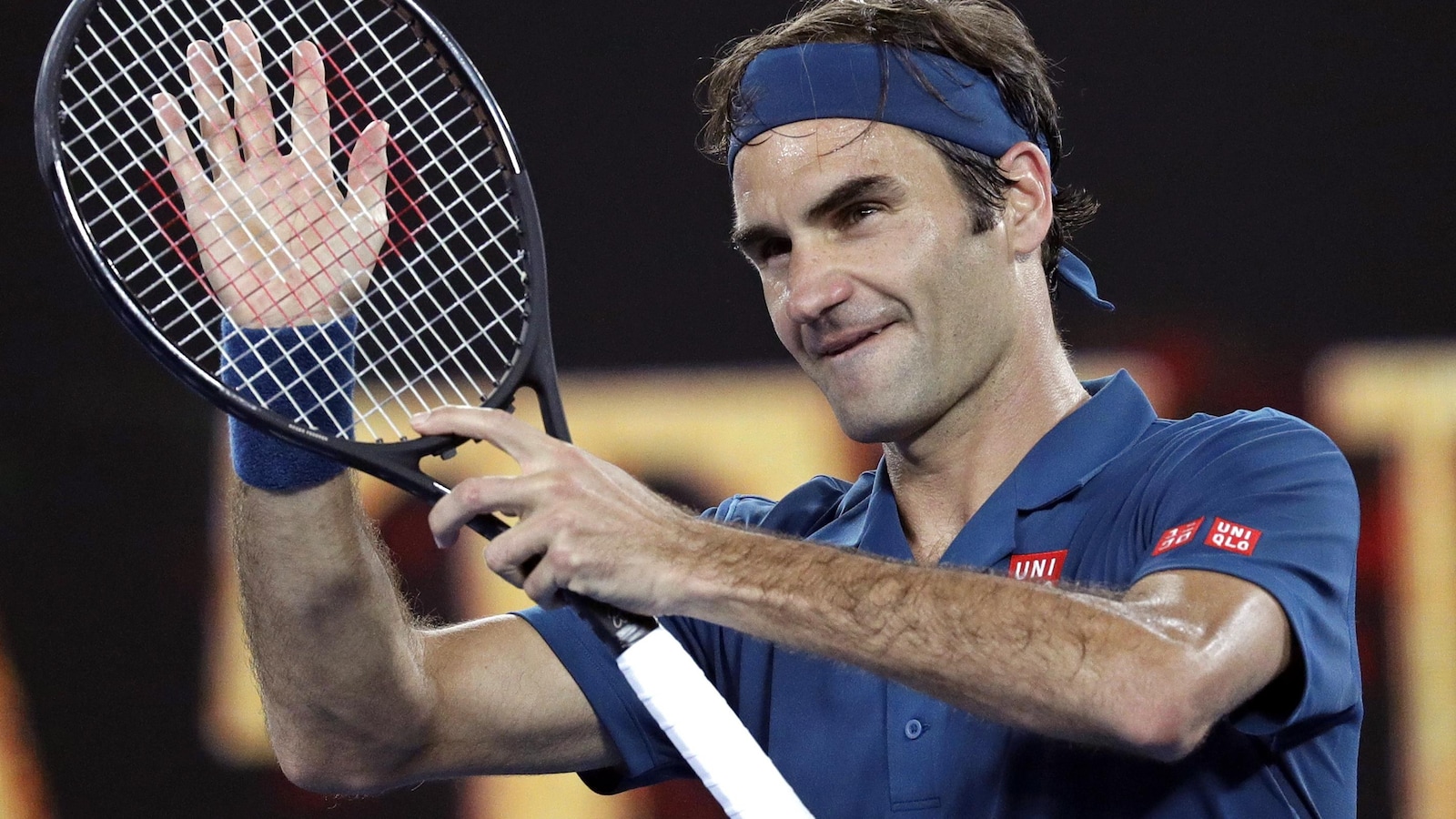 Il célèbre sa victoire contre l'Américain Taylor Fritz en frappant sa raquette de la main droite.