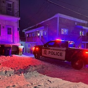Un véhicule de police dans une entrée de cour.