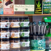 Plusieurs produits comestibles à base de cannabis sont présentés dans la vitrine d'un commerce.