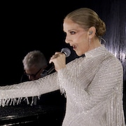 Céline Dion chante près d'un piano.