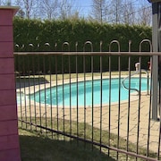 Une piscine creusée et clôturée dans une cour.