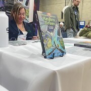 Des livres sont sur des présentoirs sur une table dans un congrès.