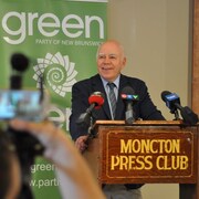 David Coon, chef du Parti vert du Nouveau-Brunswick, souriant en conférence de presse.
