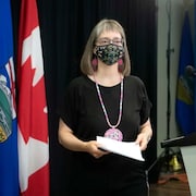 Dr. Deena Hinshaw, Alberta's chief medical officer of health, is seen leaving the podium after a June 29 news conference.