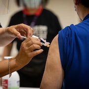 Health-care providers administer the Pfizer-BioNTech COVID-19 vaccine at a pop-up clinic in Toronto on July 27. Leading vaccines do seem to ward off serious disease that can lead to hospitalization or death, even against the delta variant. 