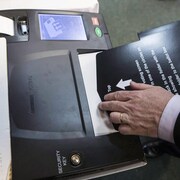 Ontario's Chief Electoral Officer Greg Essensa slides a ballot into a vote tabulator as he demonstrates an electronic voting machine during a media availability in Toronto on Wednesday, May 9 , 2018. THE CANADIAN PRESS/Chris Young
