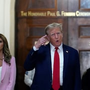 Donald Trump pointe sa tête en tournant la main.
