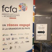Une pancarte de la Fédération des communautés francophones et acadienne (FCFA) dans un couloir.