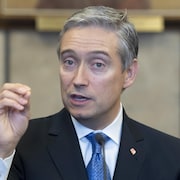 Une personne s'exprime en faisant un signe avec les doigts de sa main.