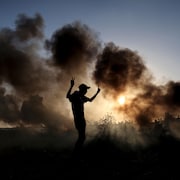 Des manifestants palestiniens brûlent des pneus lors d'affrontements avec des soldats israéliens le long de la frontière entre Israël et Gaza.