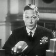 Le roi George VI faisant un discours devant un micro radio.