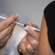 Une personne reçoit un vaccin contre la grippe.