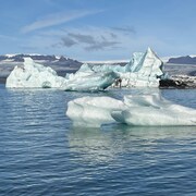 D'énormes blocs de glace flottent sur l'eau.