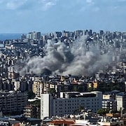 De la fumée épaisse s'élève au-dessus d'immeubles dans la ville de Beyrouth.
