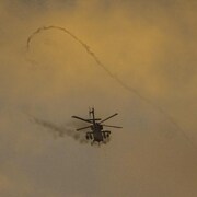 An Israeli Apache helicopter fires machine guns at the Gaza Strip on December 29, 2023.