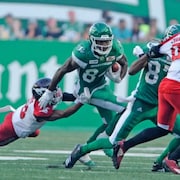Un joueur de football évite un plaqué. 