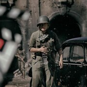 Une photographe dans une rue pendant la guerre.