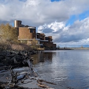 Une grande demeure en briques, construite au bord d'un lac.