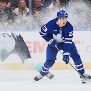 Toronto Maple Leafs' Matthew Knies (23) breaks away from Seattle Kraken's Jamie Oleksiak (24) during third period NHL hockey action in Toronto, on Saturday, Oct. 18, 2025. THE CANADIAN PRESS/Sammy Kogan