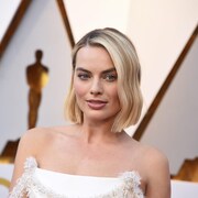 Margot Robbie pose sur le tapis rouge des Oscars.