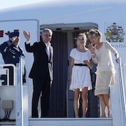 Mark Carney, accompagné de sa femme Diana Fox et sa fille Cleo, salue lors de leur embarquement dans l'avion officiel du premier ministre.