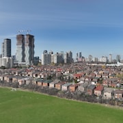 Une vue d'ensemble de Mississauga en avril 2022, avec un quartier de maisons individuelles au premier plan et des tours d'habitation au loin.